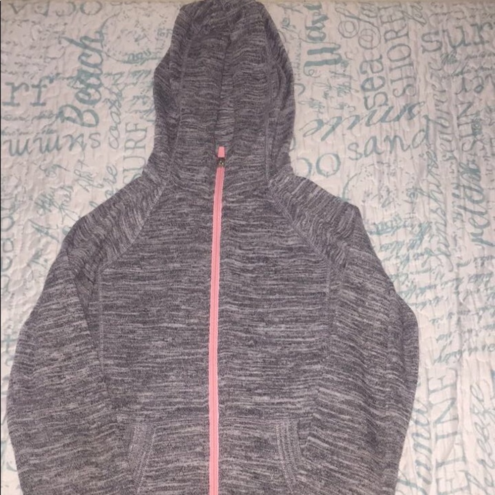 A grey sweater with a pink zipper; size M